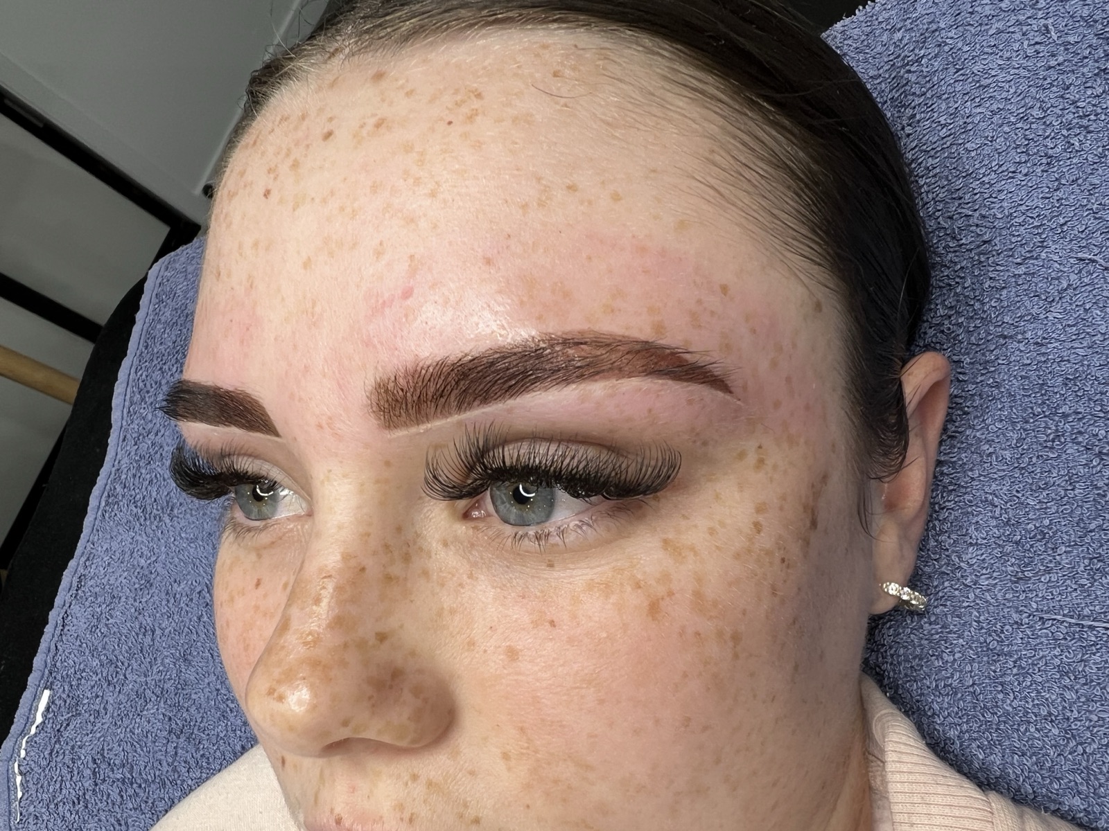Confident client with healed cosmetic brow tattoo